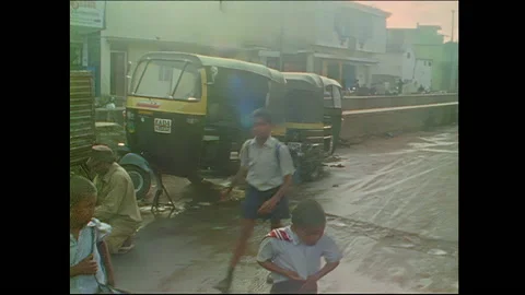 Two schoolboys walk down street - Bangalore, India Video stock 240053246