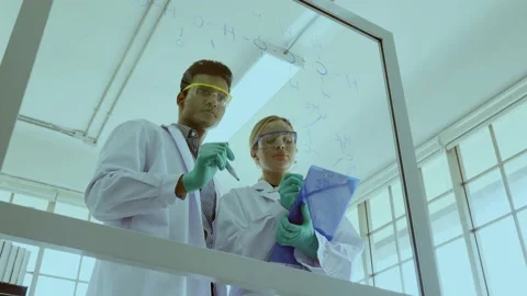 Two Scientist are writing a drug research formula in the laboratory. Video stock 140600731