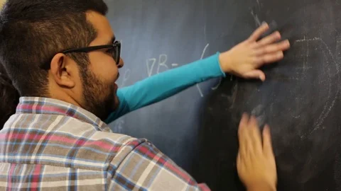 Two scientist colleagues revising equations Stock-Footage 124664420