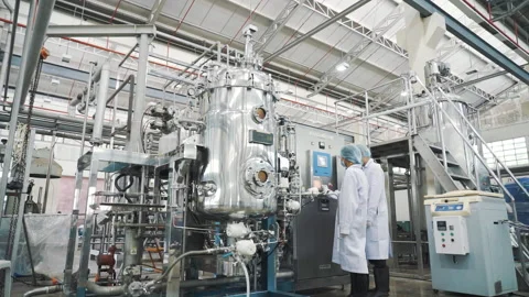 Two Scientist working with large incubator machine wide shot Video stock 158916679