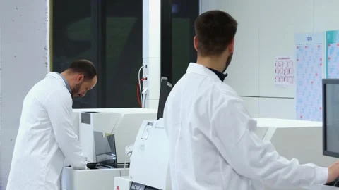 Two Scientist working with modern equipment in a research laboratory Stock Footage 296885995