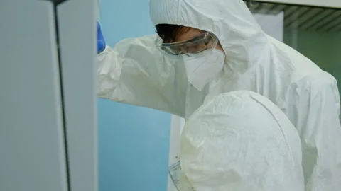 Two scientists are working in a lab to create a vaccine against the virus Stock Footage 124573430