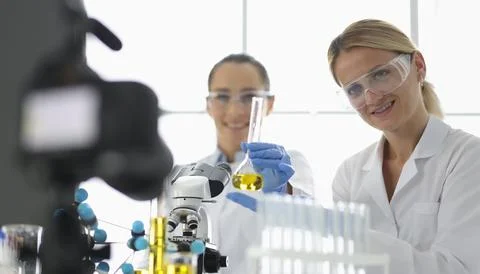 Two scientists conduct experiments in a bright lab filled with advanced Stock Photos