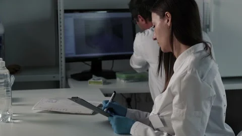 Two scientists conducting research in a lab environment Stock Footage 166027266