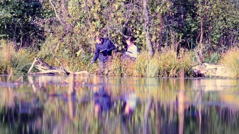 Two scientists ecologists in wild forest on the river bank Stock Footage 96271558
