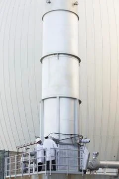 Two scientists examining an exhaust stack Stock Photos