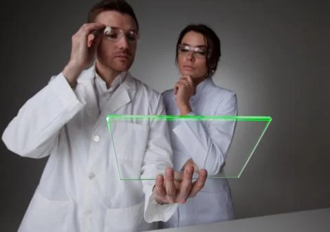 Two scientists with futuristic tablet Stock Photos