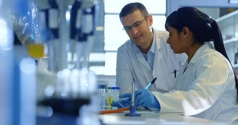 Two scientists interacting with each other 4k Stock-Footage 96093777