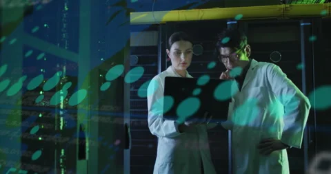Two scientists launching diagnostic software in server room, displaying floating Stock Footage 310327198