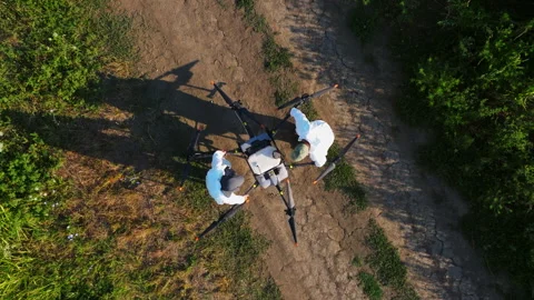 Two scientists placing large agricultural drone on its take-off position. Stock Footage 322172061