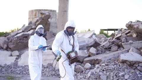 Two scientists in protective suits and masks and a personal ionizing radiation Stock Footage 110440778