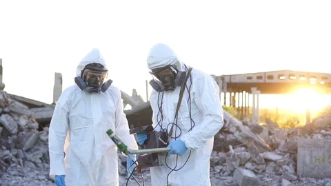 Two scientists in protective suits and masks and a personal ionizing radiation Stock Footage 110441304