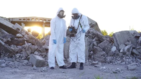 Two scientists in protective suits and masks and make measurements of radiation Stock Footage 110748712