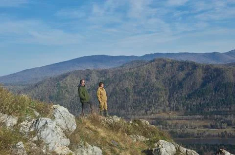 Two scientists standing on top of a hill Stock Photos