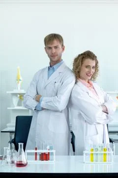 Two scientists stood confidently with folded arms Stock Photos