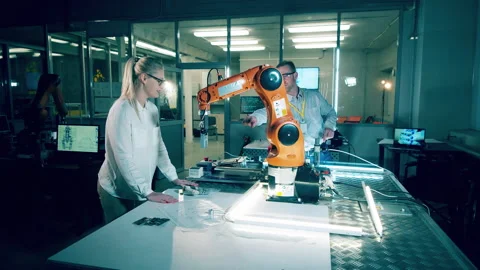 Two scientists work with the bionic arm in modern laboratory Stock Footage 240317590