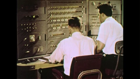 Two scientists work together to work the circuits of a computer by turning them Stock Footage 74451381