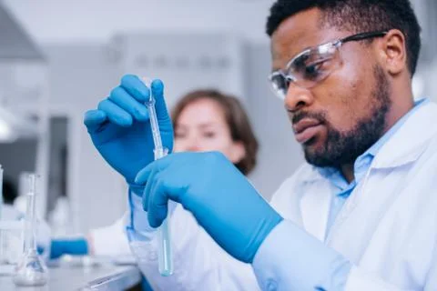Two scientists working with testing tubes in the lab. Stock Photos