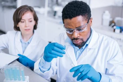 Two scientists working with testing tubes in the lab. Stock Photos