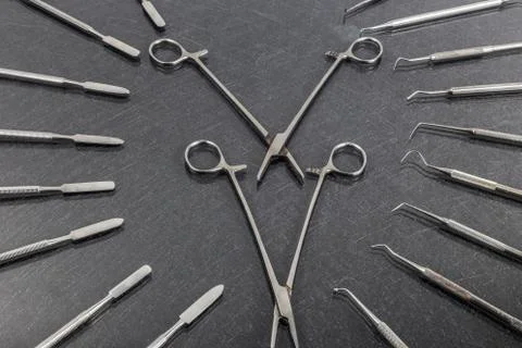 Two scissors lay in different dental instruments on background Stock Photos