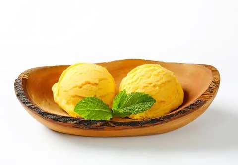 Two scoops of yellow lemon ice cream in bowl Stock Photos