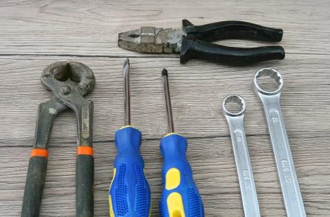 Two Screwdrivers, Two Wrenches, Two Pliers Isolated on Desk Stock Photos