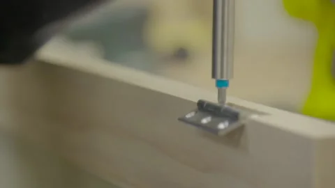Two screws attaching hinge to wood 스톡 동영상 163413477