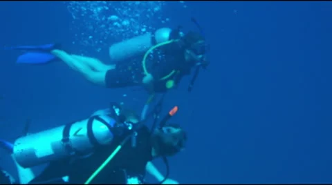 Two scuba diver swimming under water. Stock Footage 53521398