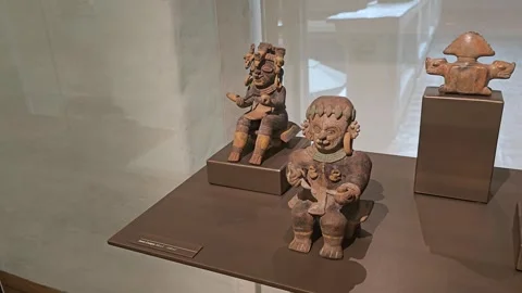 Two Seated Figures Beside a Plinth, Casa del Alabado, Quito, Ecuador 8K Video stock 331493333