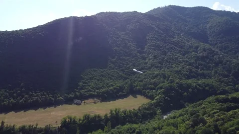 Two-seater hang glider approaching during landing. Stock Footage 285953858