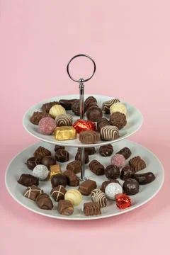 Two section cake stand with chocolate candies. Two tier plate Stock Photos