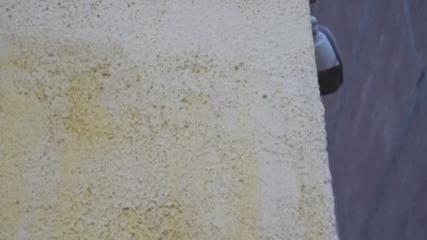 Two security cameras on a brick elementary school, looking out over a parking Stock Footage 76864667