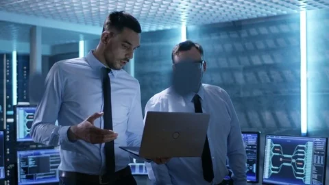 Two Security Engineers Walking In System Control Center. They Have Discussion. Stock Footage