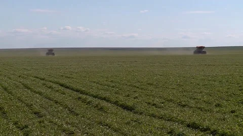 Two self propelled fertilizer spreaders spraying on a green field. overall plan Stock Footage 130269234