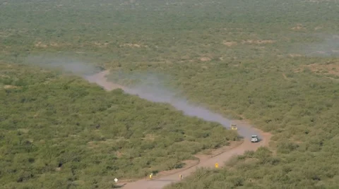 Two semi trucks heading up a mountain dirt road Stock Footage 58102451