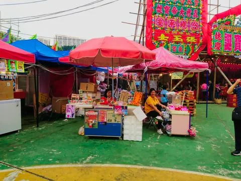 Two senior citizens set up two food stalls selling traditional Hong Kong candies Stock Photos