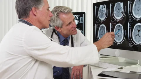 Two senior doctors working on computers Vídeo Stock