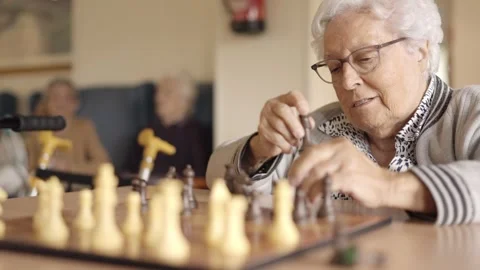 Two senior friends playing chess board game in a geriatric Video stock 268748835