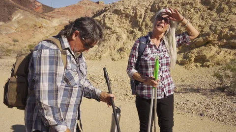 Two senior is hiking at rocks area during sunshine weather. Stock Footage 252785261