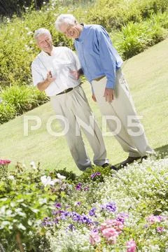 Two senior men in a flower garden Stock-Fotos