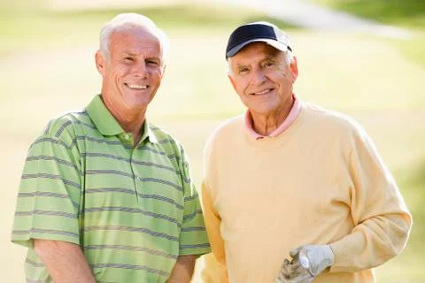 Two senior men in a golf field Photos