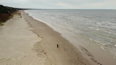 Two senior women walking on empty Autumn Jurmala beach Baltic Sea Latvia Stock Footage 325974761