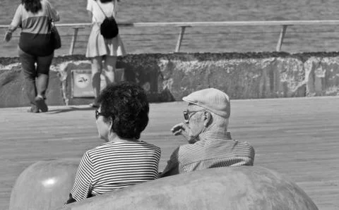 Two seniors sitting on a bench Stock Photos