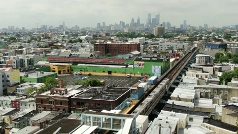 Two SEPTA subway trains pass each other in Kensington neighborhood, Philly Stock Footage 137429541