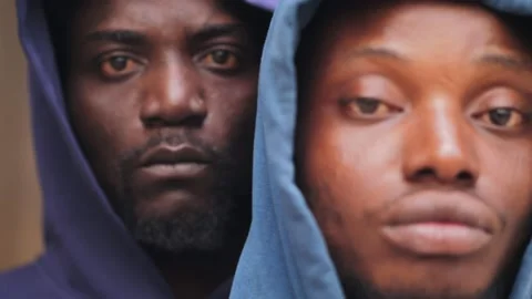Two serious african men looking at camera in urban city with black hat Видео 218614721