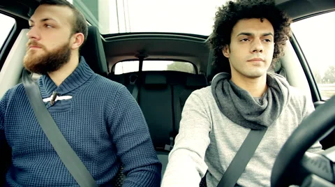 Two serious men driving car angry Stock Footage 48561817