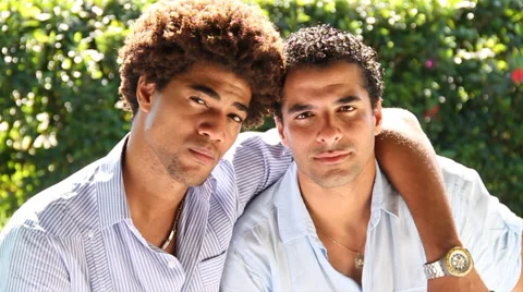 Two serious young men look at each other and to camera Stock Footage 38762068