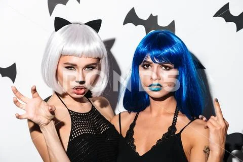 Two serious young women in halloween costumes Stock Photos