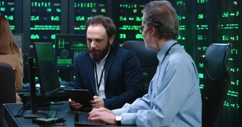 Two server room employees work together at same table. Male system Stock Footage 145284401