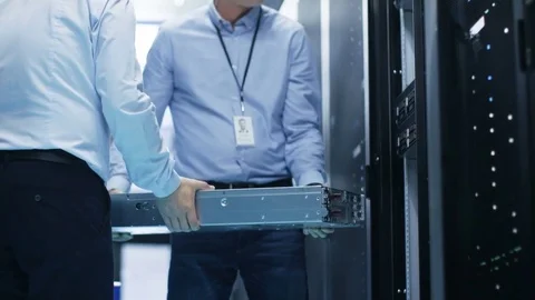 Two Server Technicians Install Hardware in Server Rack.  Stock Footage 74630775